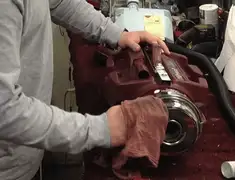 Vacuum repair technician cleaning and servicing a vacuum motor in Pueblo, CO